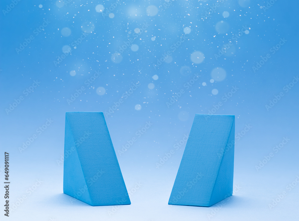 Wall mural two empty geometric triangle podiums for display your product. blue background with light bokeh, fal