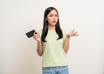 Pretty young asian woman using smartphone feeling upset confused bad depressed emotional standing on isolated white background. Holding cell phone. Thinking and stressed