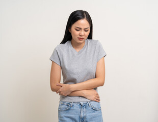 A woman had a stomach ache and gastritis. She put her hand on her stomach and squeezed it to relax and soothe. Unwell unhealthy female menstrual cramps on isolated white background.