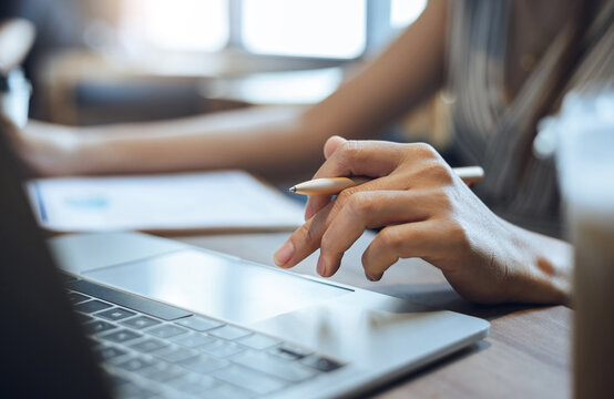 Young asian woman using a laptop computer find information about doing business online to start new business, close-up view