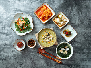Abalone porridge, clam seaweed soup, and various side dishes	