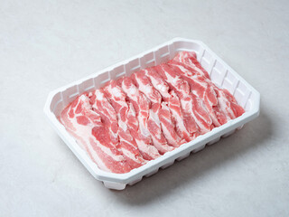 Raw pork belly in a packaging container
