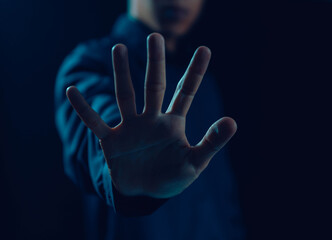 Man hand showing palm gestures stop, concept violence, traffic, refuse, defense, caution, sign stop dark background 