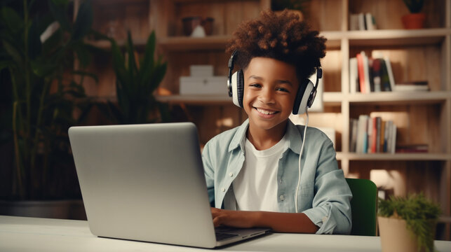 Smiling African American child school boy studying online on laptop at home 