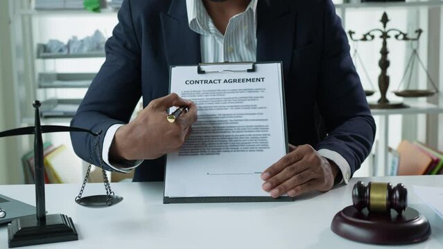 The lawyer or legal advisor reads and carefully checks the validity of documents and investment agreements for signing contracts managing justice concepts.