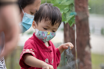 Happy Kids play and feeding to a adorable rabbit at rabbit farm