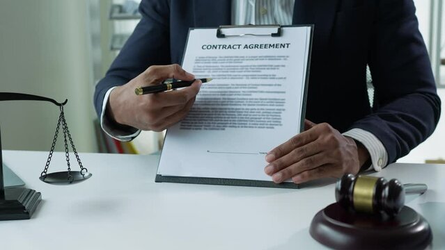 The lawyer or legal advisor reads and carefully checks the validity of documents and investment agreements for signing contracts managing justice concepts.