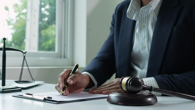 The lawyer or legal advisor reads and carefully checks the validity of documents and investment agreements for signing contracts managing justice concepts.