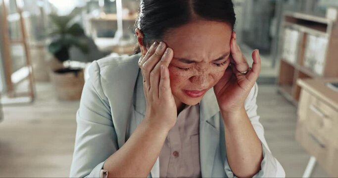 Business woman, burnout and headache in office for mistake, vertigo and crisis of brain fog, mental health and debt. Face of frustrated asian employee with stress, fatigue and massage temple for pain