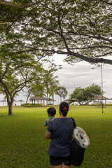 Happy Asian Mother and Kids enjoying family time on beautiful clean beach