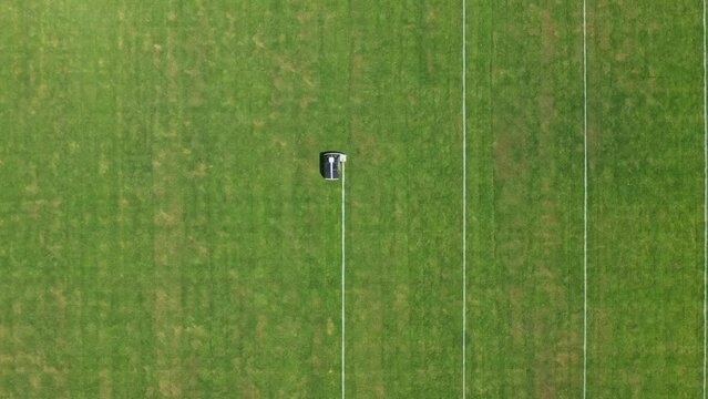 Robot painting white lines on the playing field. Top aerial view.