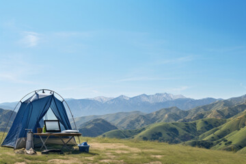 Working amidst nature: a laptop set by a tent overlooking serene mountains, embodying the fusion of work and leisure