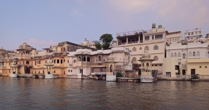 Udaipur Lal Ghat old houses and haveli view from boat. Rajput architecture of Mewar dynasty rulers tourist Indian landmark. Incredible India. Horizontal camera truck