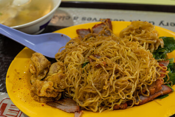 A tantalizing plate of Singapore's iconic Wan Tan Mee, showcasing the perfect balance of flavors...