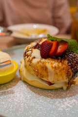 A visual treat of a perfectly risen soufflé infused with the richness of cheesecake and the vibrant burst of berry flavors, a dessert that embodies both elegance and indulgence