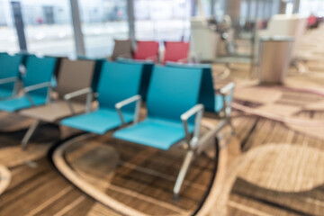 A serene airport waiting area filled with rows of plush chairs, offering travelers a peaceful retreat as they await their flights.