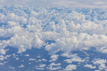 A breathtaking view captured from inside an aircraft, revealing an expansive and beautiful cloudscape.