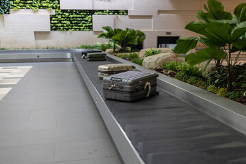 luggage suitcase on the conveyor wait for passenger come to claim it at Terminal 3, Changi Airport, Singapore