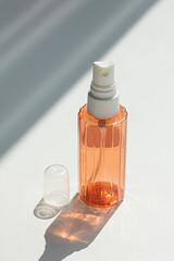 Empty spray bottle with cap isolated on white.