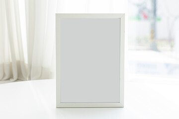 Blank frame photo on white table.