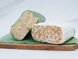 raw tempeh or tempe. Fresh tempeh still wrapped in banana leaves. Tempeh is made from fermented soybeans