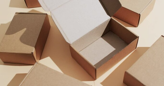 Video of cardboard boxes with copy space over brown background