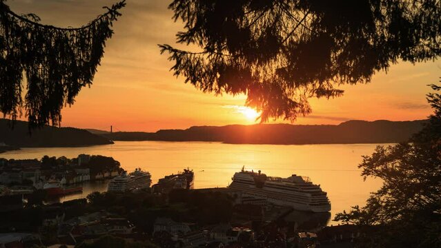 Day to night timelapse of Bergen. Beautiful sunset with cruise ship departing in the orange light