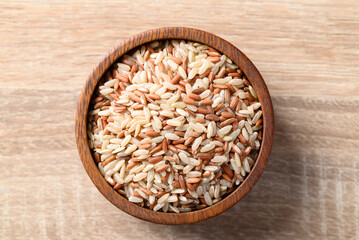 Thai brown rice seed in wooden bowl, Organic rice, Healthy food ingredient