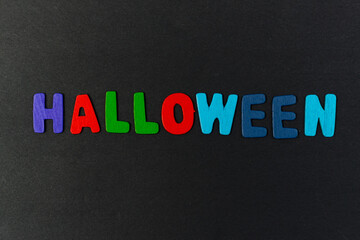 colorful letters with the word Halloween on a black background