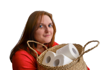 A woman holds rolls of toilet paper in a large basket, close-up, isolated on a white background. Problems with toilet paper in the shops because of the quarantine