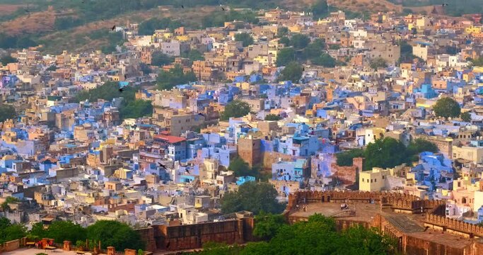 Houses and roofs of famous tourist landmark Jodhpur, the Blue City, aerial view from Mehrangarh Fort, Rajasthan, India. Camera zoom in