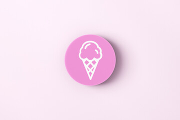 Ice cream symbol on a pink round button on pink background.