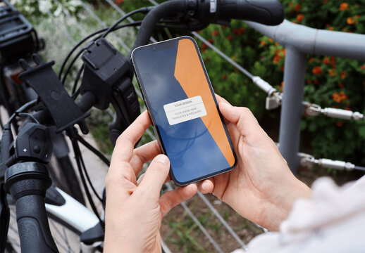 Mockup of person using smartphone with customizable screen on bicycle