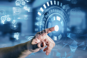 Close up of male hand pointing at glowing digital business interface with cogwheels and other icons on blurry office interior background. Future, innovation and technology concept.