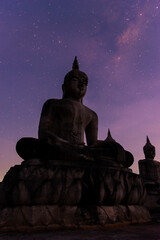 Big buddha stature with milky way galaxy night sky