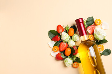 Glass bottle with wine, roses and fruits on beige background, space for text