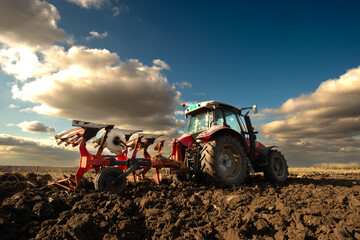 Red Tractor Plowing in sunset