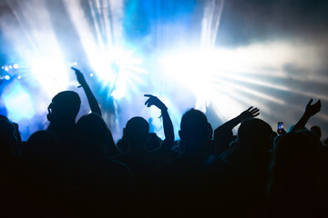 Fototapeta premium Abstract photo of crowd at concert and blurred stage lights.