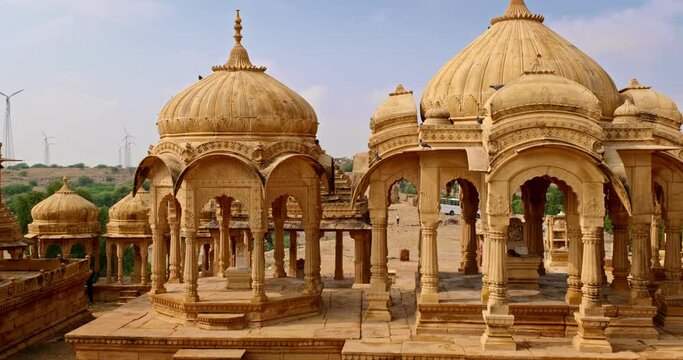 Bada bagh cenotaphs (Hindu tomb mausoleum) made of sandstone in Indian Thar desert. Jaisalmer, Rajasthan, India. Horizontal panning