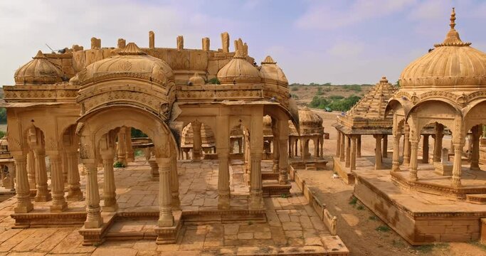 Bada bagh cenotaphs (Hindu tomb mausoleum) made of sandstone in Indian Thar desert. Jaisalmer, Rajasthan, India. Horizontal panning