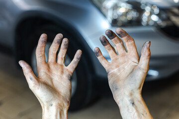 Mechanic with dirty hands from grease after working with a car. Dirty hands of a man after work.