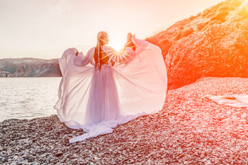 Mysterious woman silhouette long hair walks on the beach ocean water, sea nymph wind listens to the...