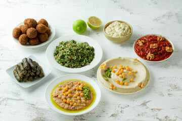 Arab middle eastern traditional breakfast dishes of hummus, beans, salad, falafel, Dolma and sauce.