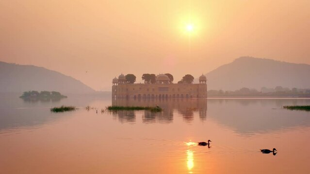 Famous indian tourist landmark Jal Mahal (Water Palace) at sunrise in Jaipur. Ducks and birds around enjoy the serene morning. Jaipur, Rajasthan, India, Asia
