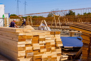 Makeshift storage at outdoor with wooden boards placed in a row on the building site
