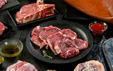 plate of of fresh tender beef on black background, shank meat, flank meat, rib meat ,chuck meat, round meat 2
