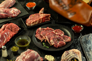 plate of of fresh tender beef on black background, shank meat, flank meat, rib meat ,chuck meat, round meat