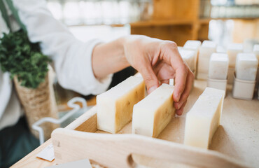 Hand of woman picking scented soap in shop