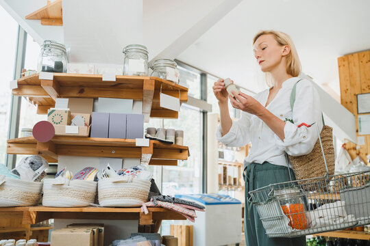 Blond woman looking at merchandise in zero waste shop
