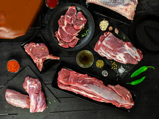 Collection of fresh tender beef on black background, shank meat, flank meat, rib meat ,chuck meat, round meat from top view 4